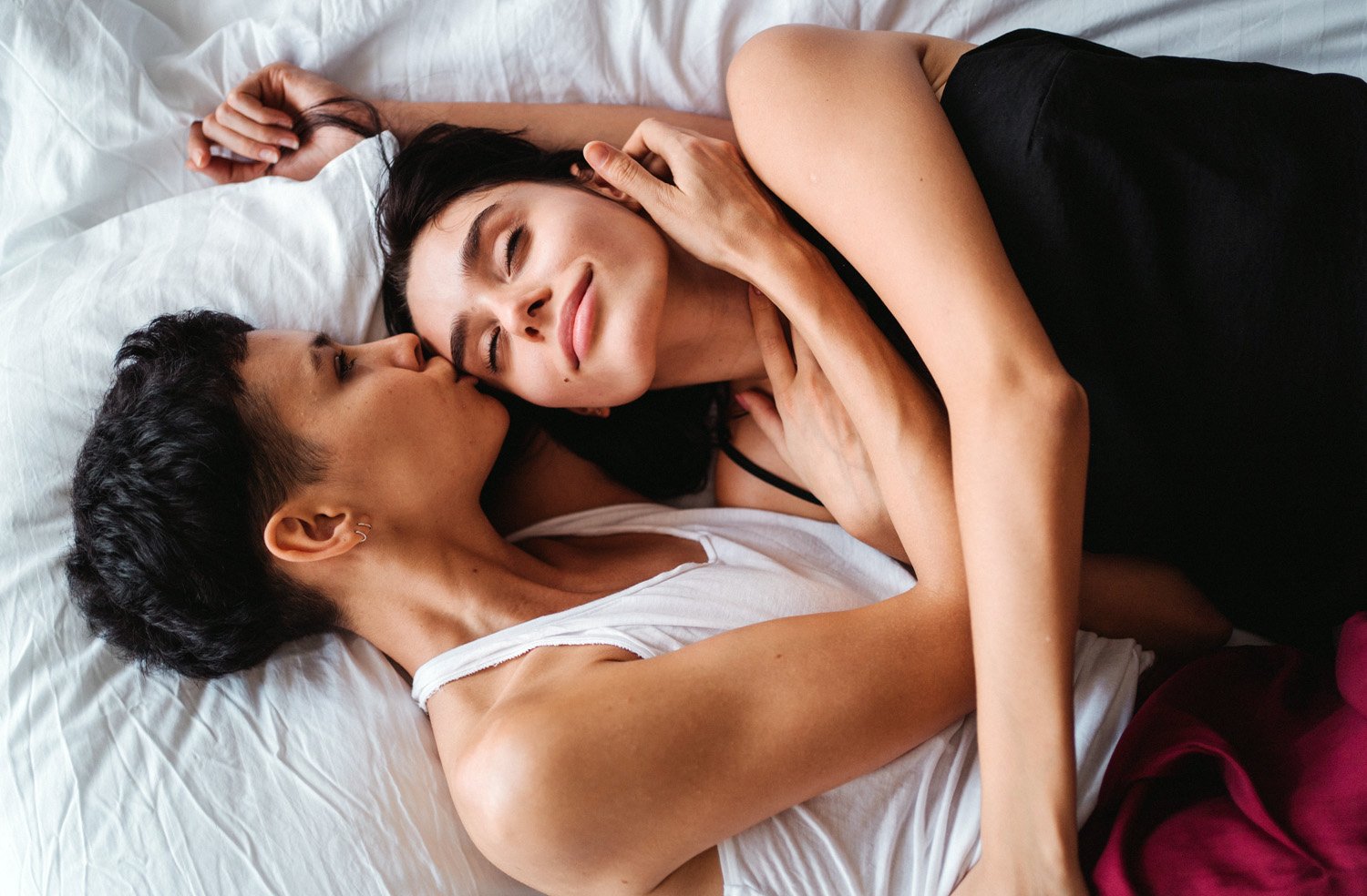 Two women in bed, practicing the psychology of female arousal