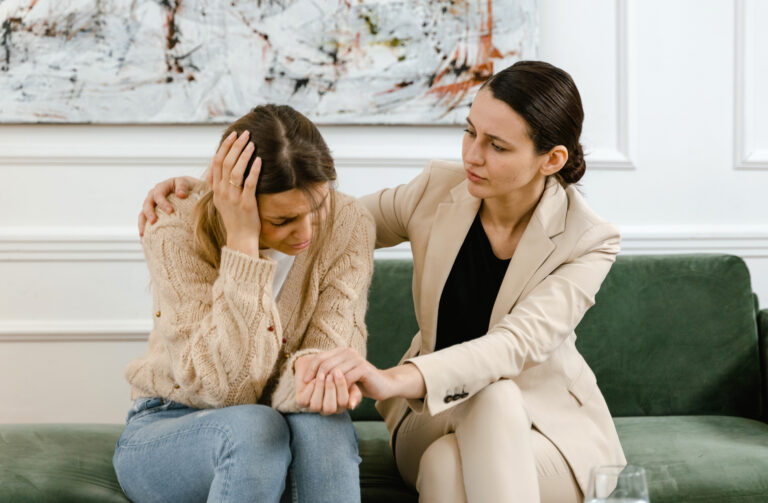 Trauma-empowerment coach soothing a client